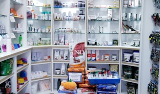 assorted food cans on white shelf