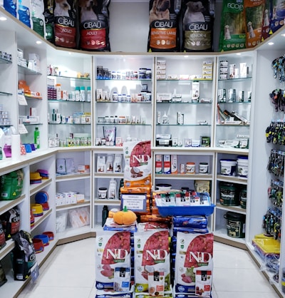 assorted food cans on white shelf