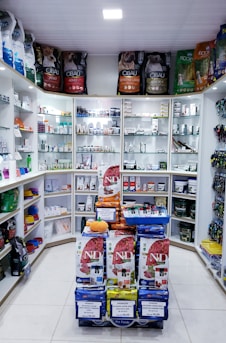 Assorted herbal products, oils, spices, sauces, and chutneys from Malik Enterprises on a store shelf