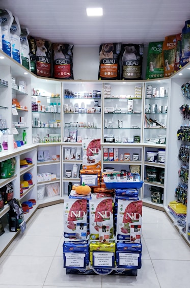 Assorted herbal products, oils, spices, sauces, and chutneys from Malik Enterprises on a store shelf