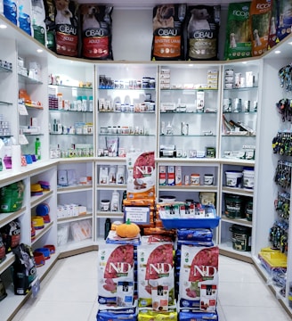 assorted food cans on white shelf