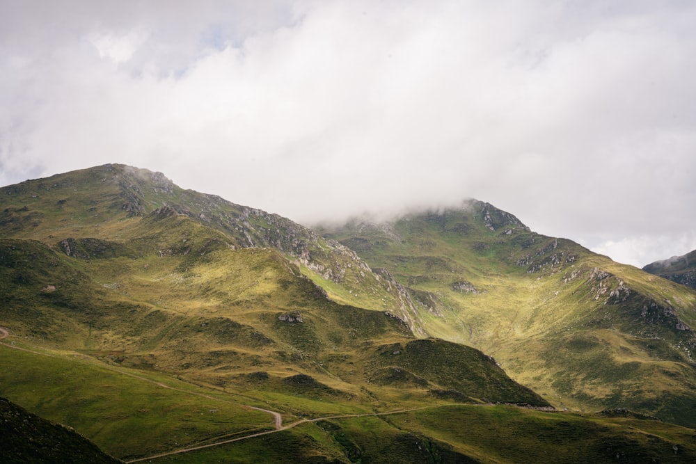 green mountain under white clouds during daytime