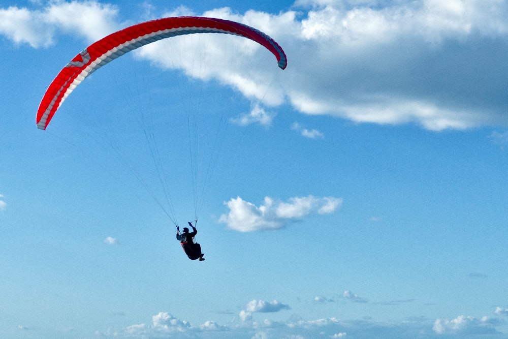 person in black and white parachute under blue sky during daytime