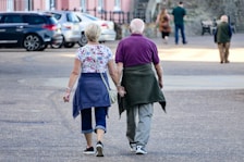 man and woman walking on the street during daytime