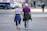 man and woman walking on the street during daytime