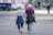 man and woman walking on the street during daytime