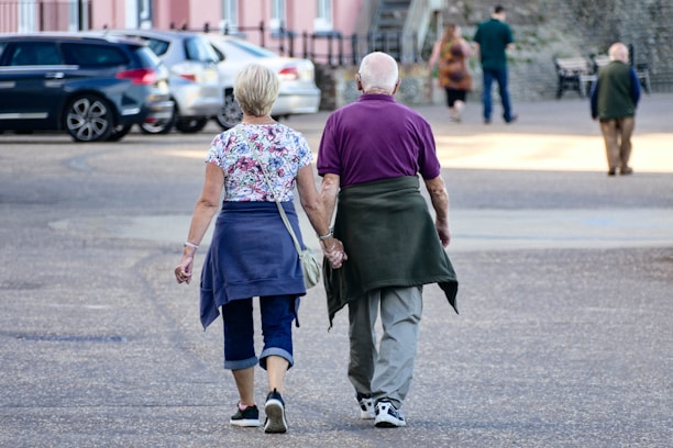 man and woman walking on the street during daytime