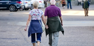 man and woman walking on the street during daytime