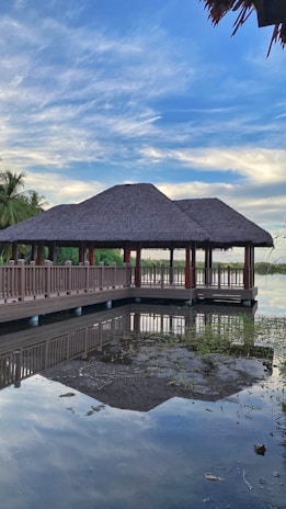 A serene tropical pavilion with open wooden beams blending seamlessly into lush Lombok greenery.