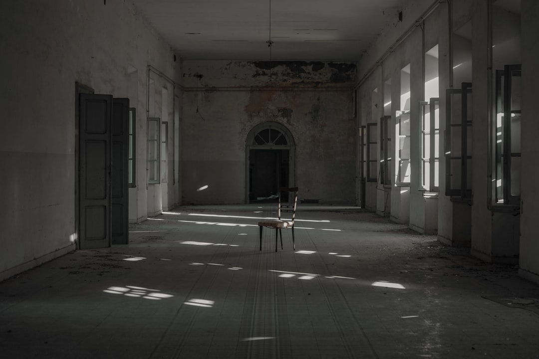 person in white shirt sitting on chair, Abandoned chair.