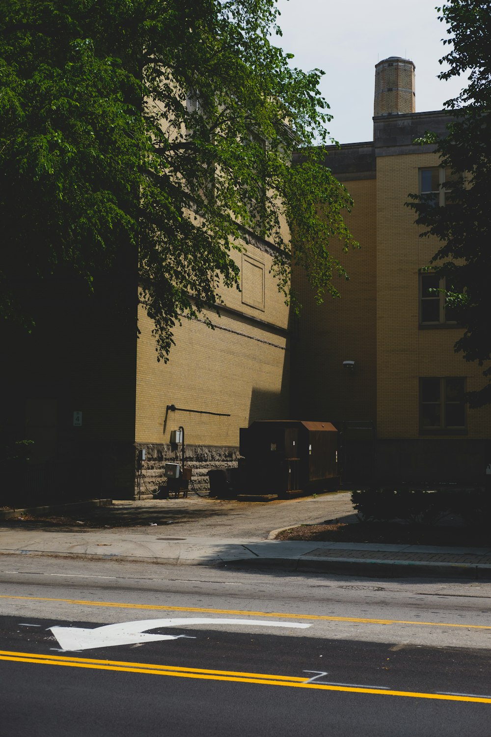 brown concrete building near green trees during daytime