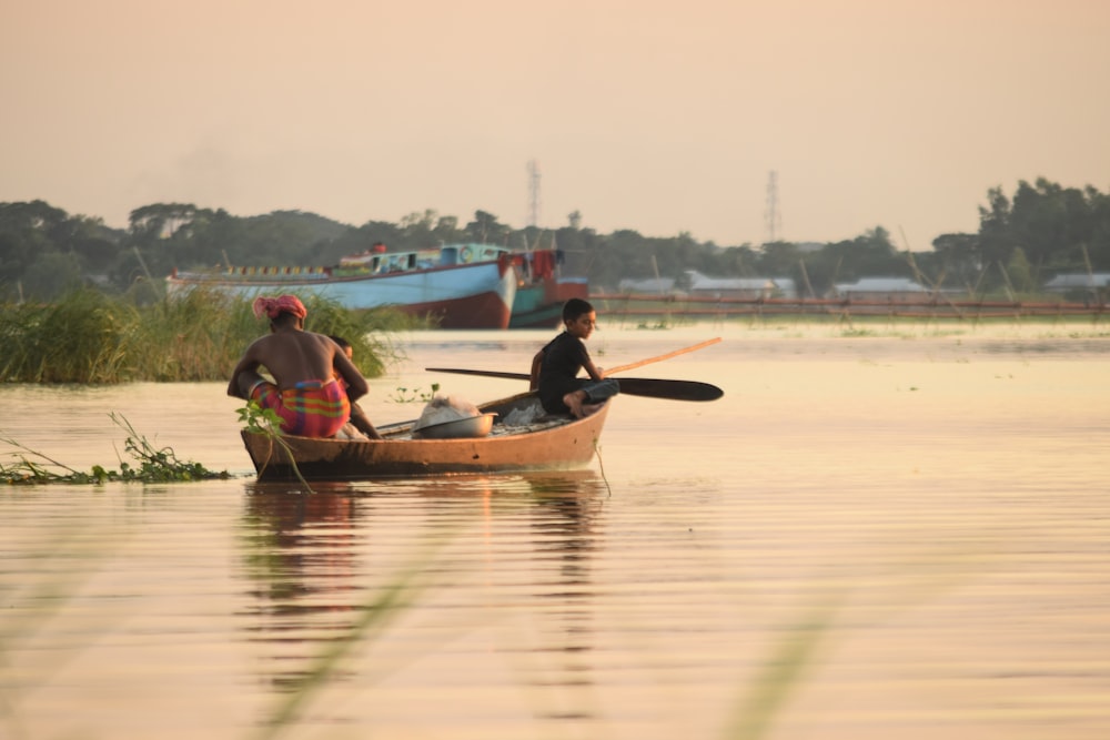 man and woman riding on boat on lake during daytime