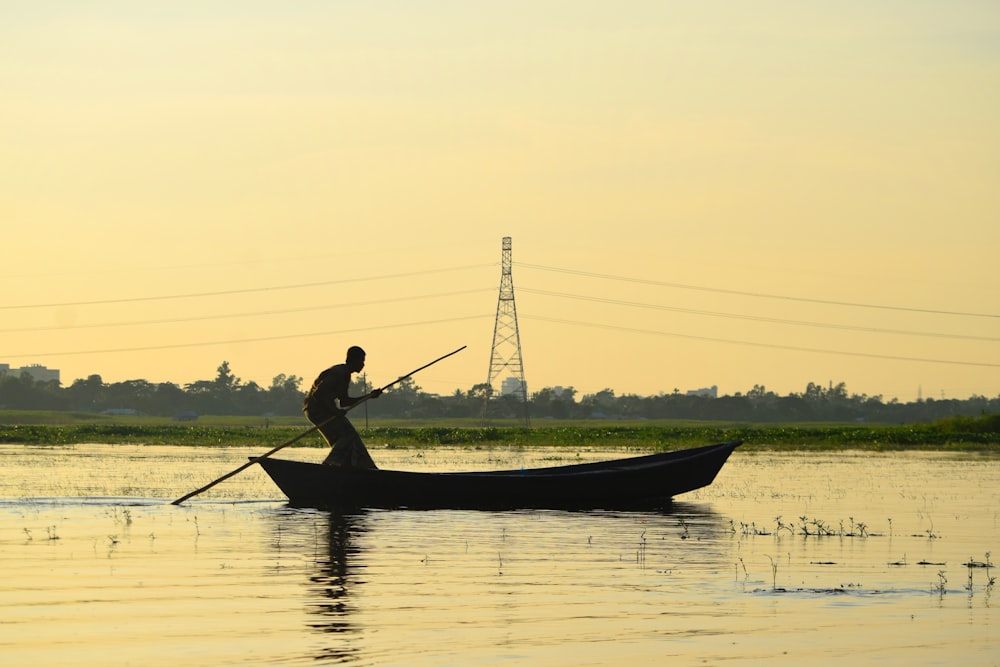 man in black shirt riding on boat during daytime