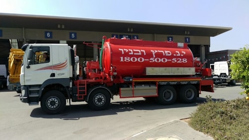 A water tanker parked near a residential building.