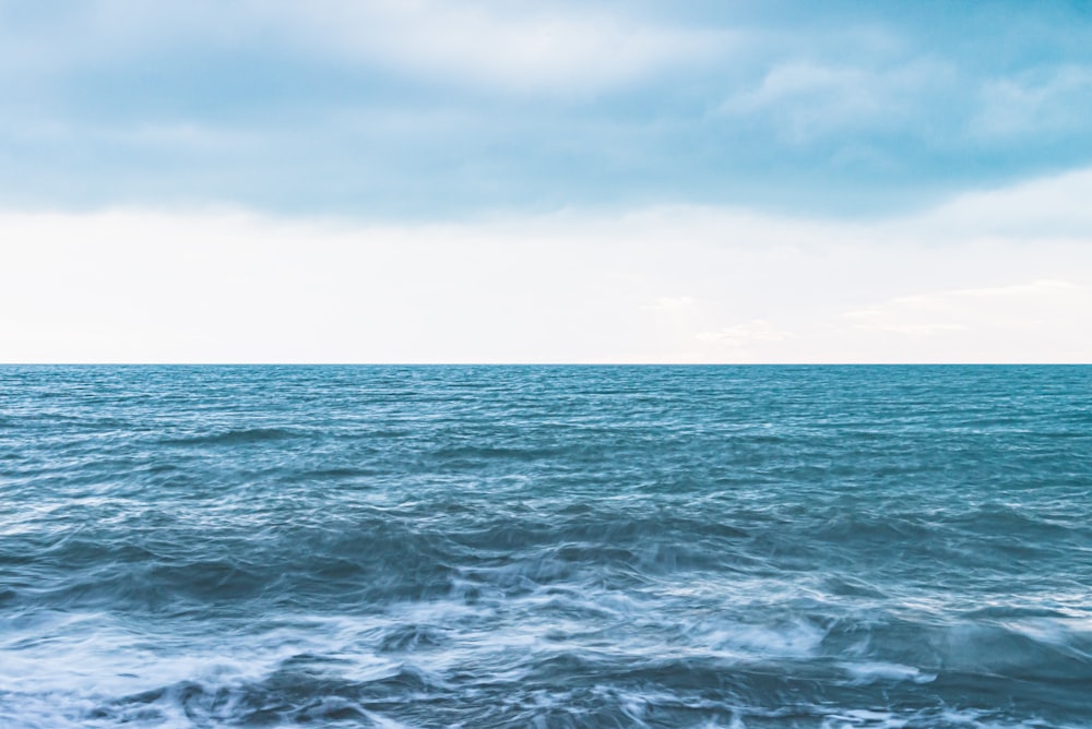 ocean waves under blue sky during daytime