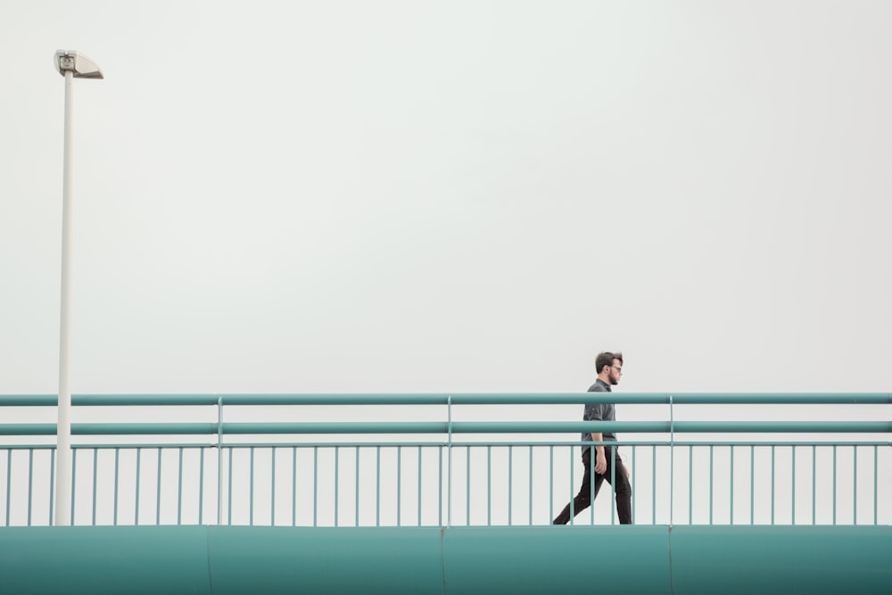 2 women standing on a white metal fence