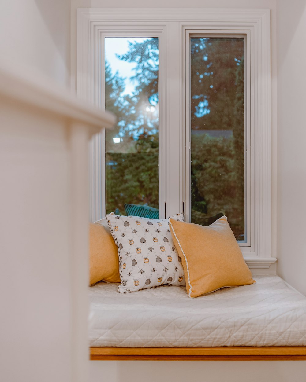 cojines blancos y marrones sobre cama blanca