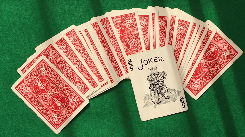 joker playing card on green textile