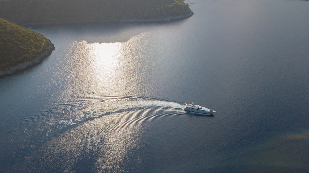 white and blue boat on body of water during daytime