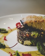 A close-up of a gourmet dish being plated.