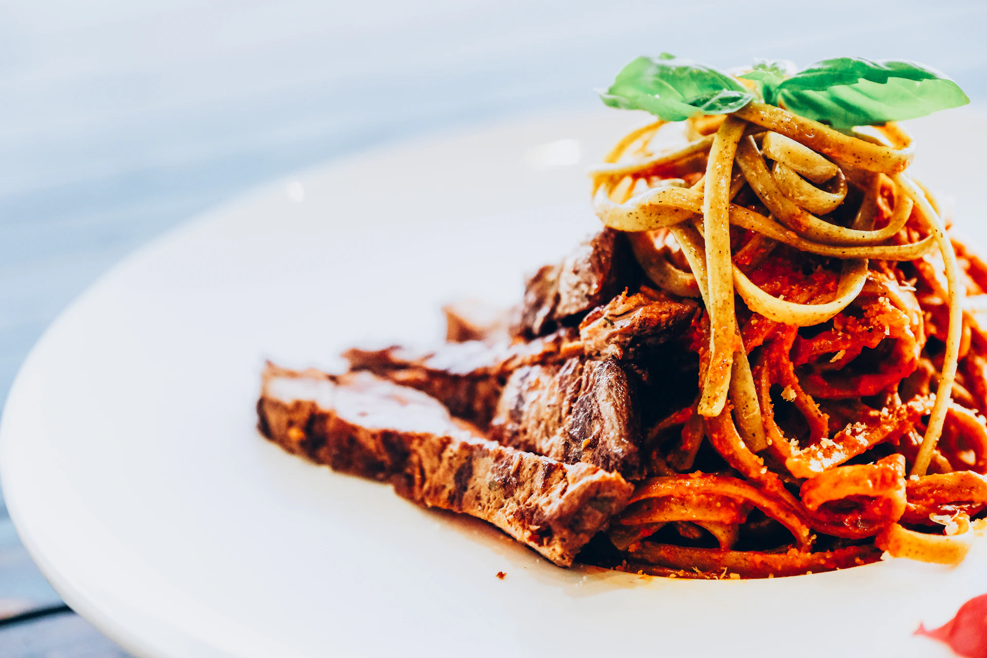 cooked meat with green vegetable on white ceramic plate
