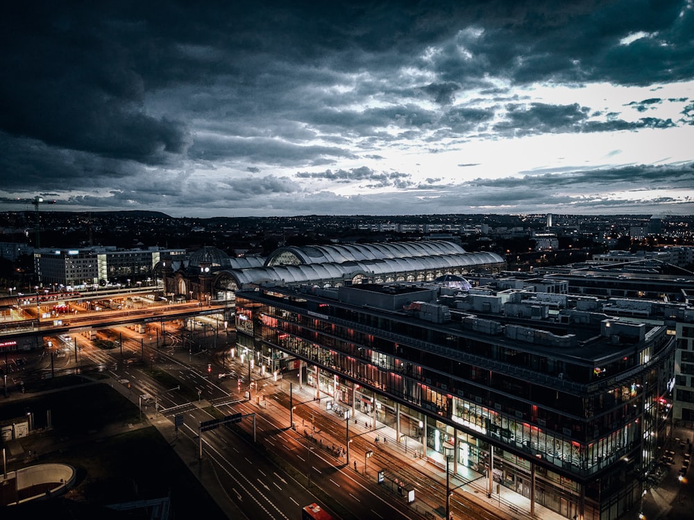 city buildings under gray clouds during night time