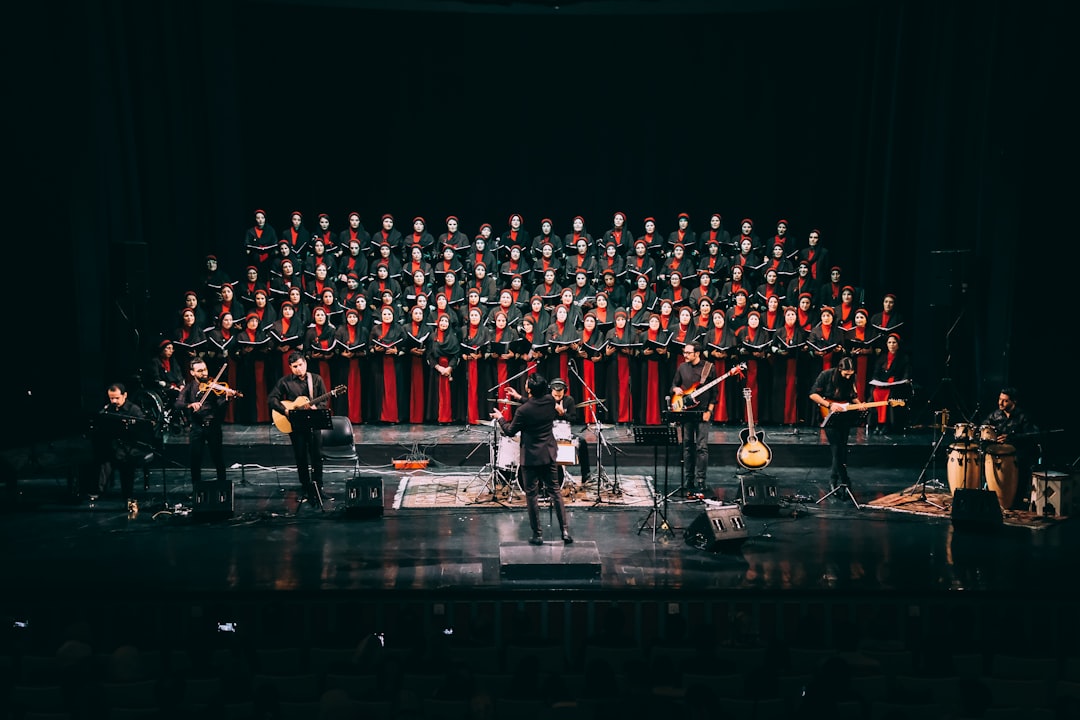 people in red and black suits on stage