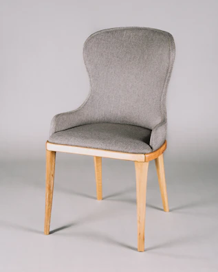 A modern fabric club chair in soft gray with sleek metal legs.