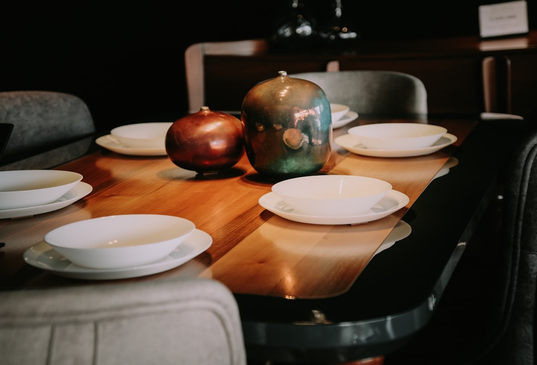 white ceramic plate on brown wooden table