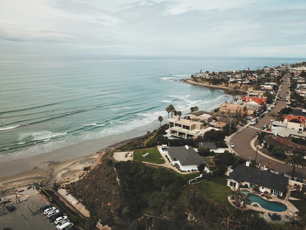 aerial view of houses near sea during daytime