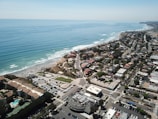 aerial view of city buildings near sea during daytime