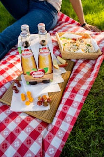 An outdoor picnic scene featuring people enjoying various sodas.