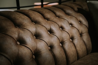 black leather tufted headboard in close up photography