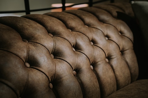 black leather tufted headboard in close up photography