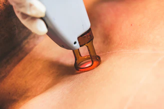person holding white and orange device