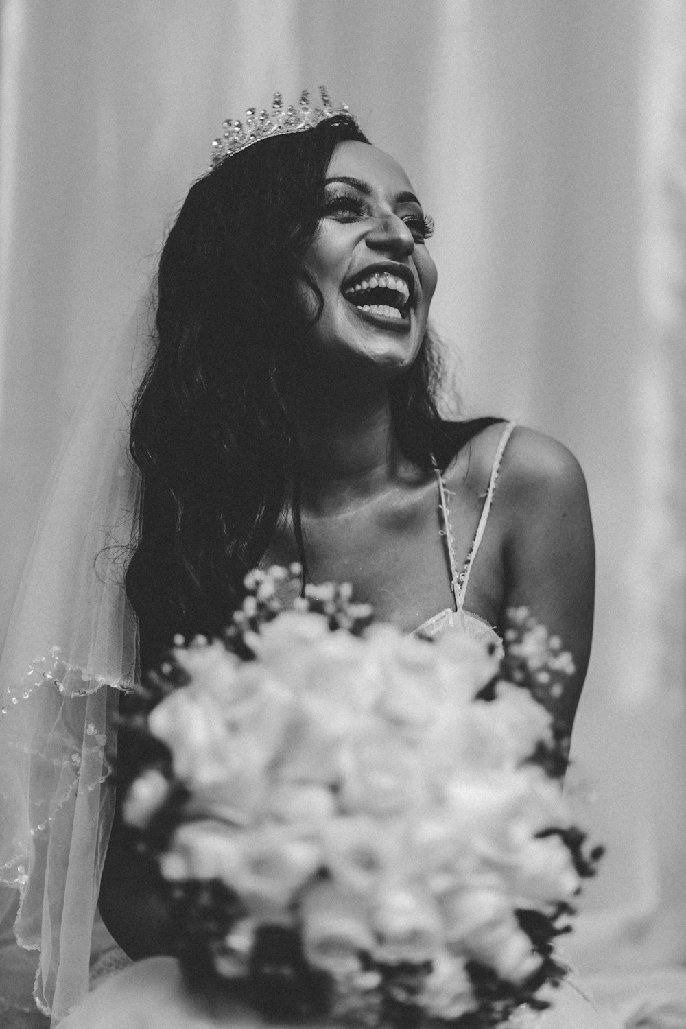 woman in white spaghetti strap top smiling