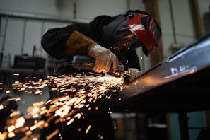 person in black jacket holding brown wooden rolling pin