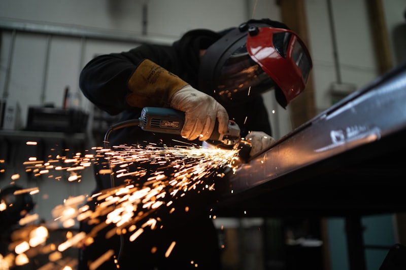 Precision cutting of a steel beam with sparks flying