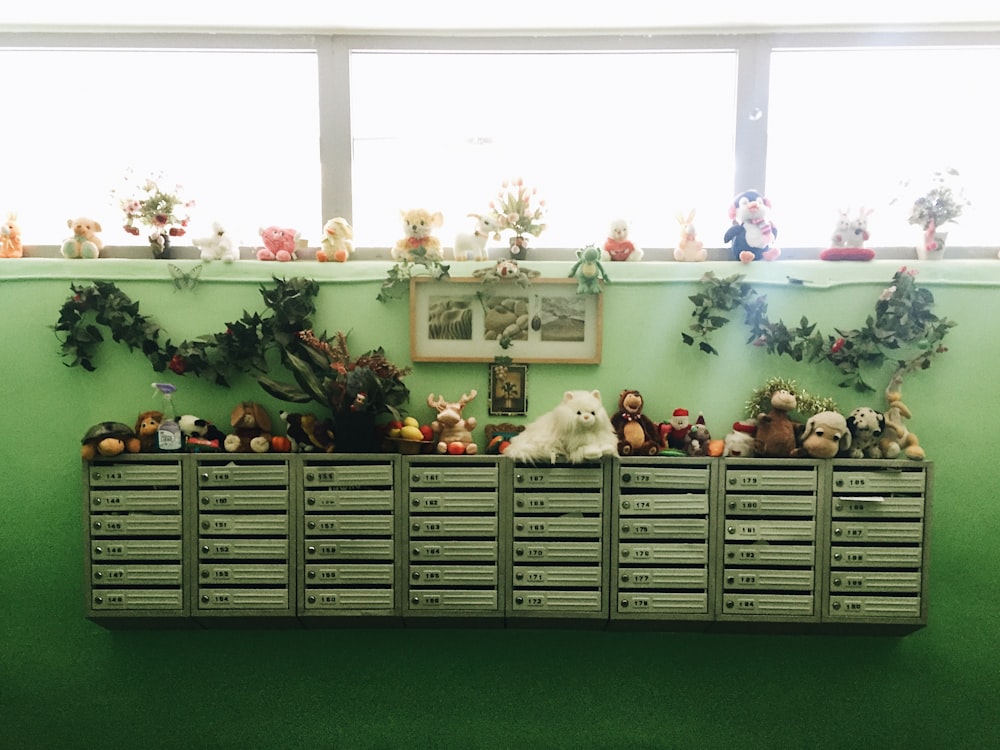 plush toys on white wooden shelf