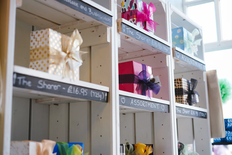 Handmade ceramics and owl-inspired pottery pieces on a display shelf
