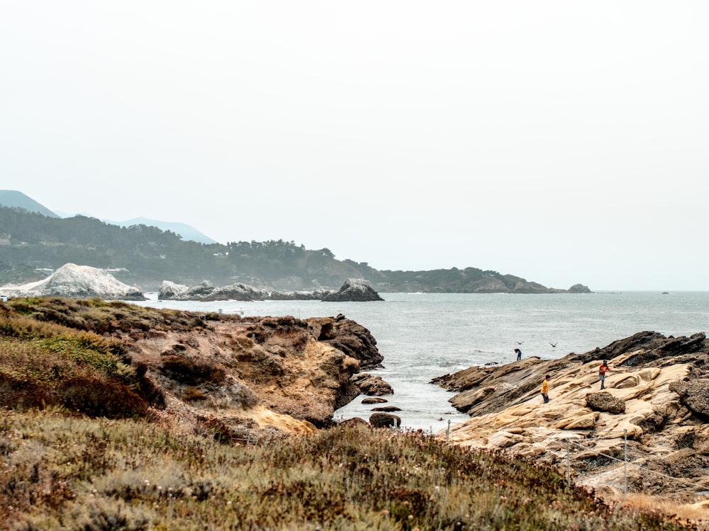 brown rock formation near body of water during daytime