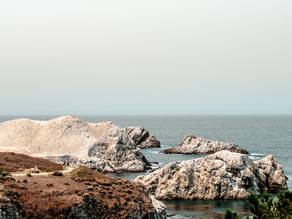 brown rocky shore under gray sky during daytime