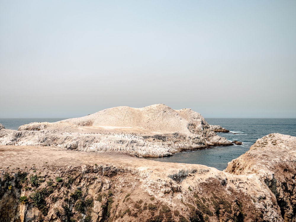 brown rock formation on sea shore during daytime