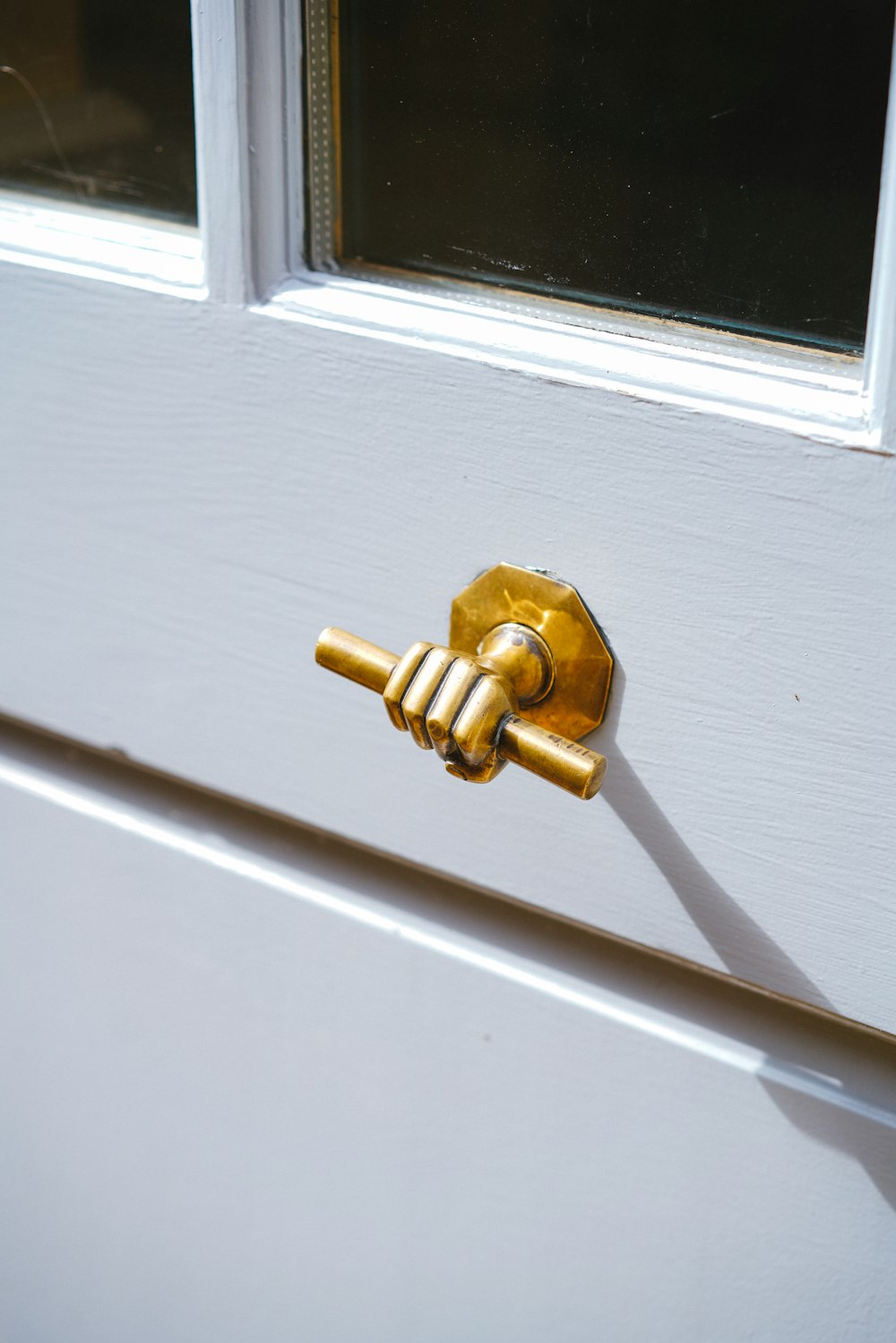 a golden door handle on a white door