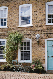 brown brick house with white wooden door