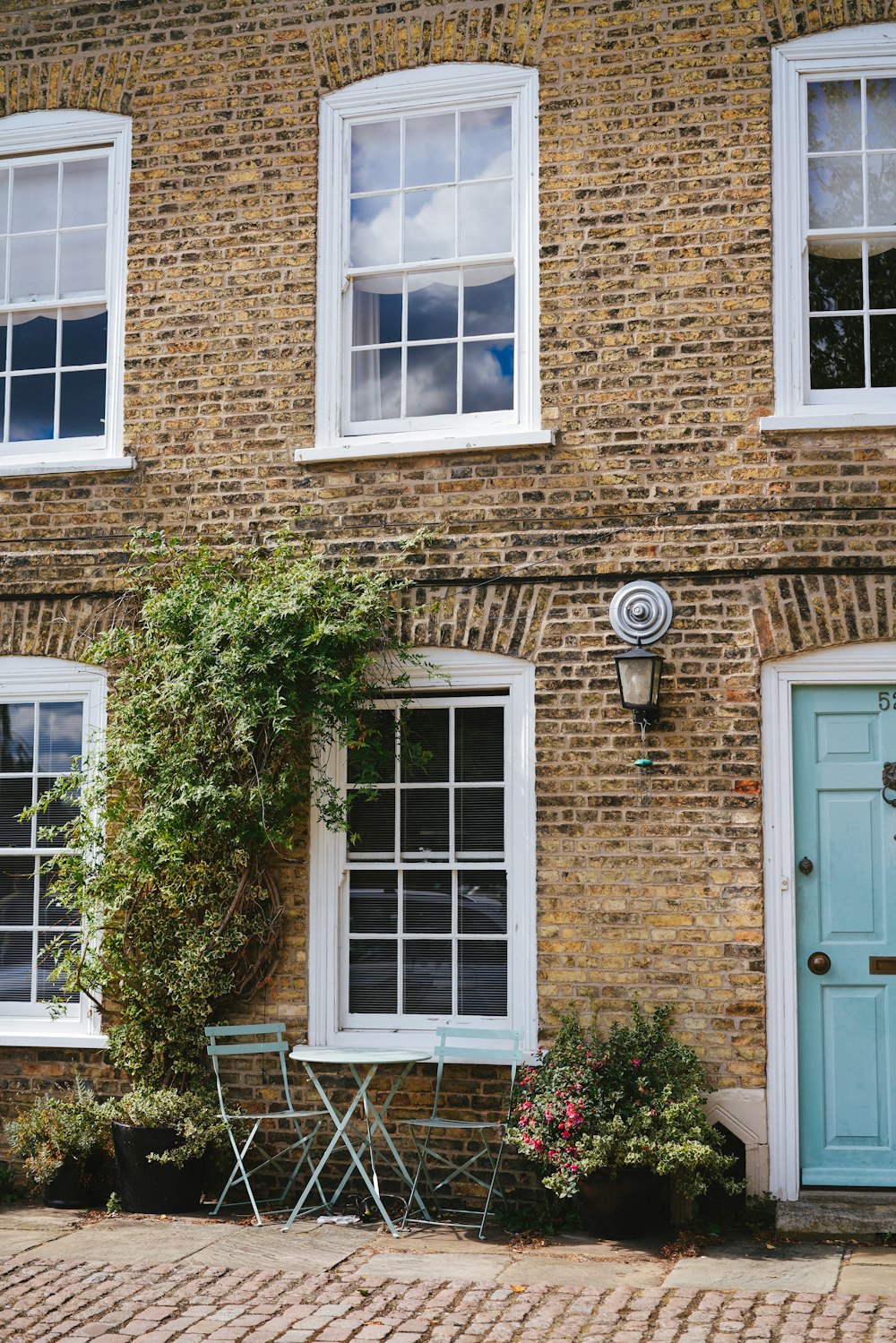 brown brick house with white wooden door