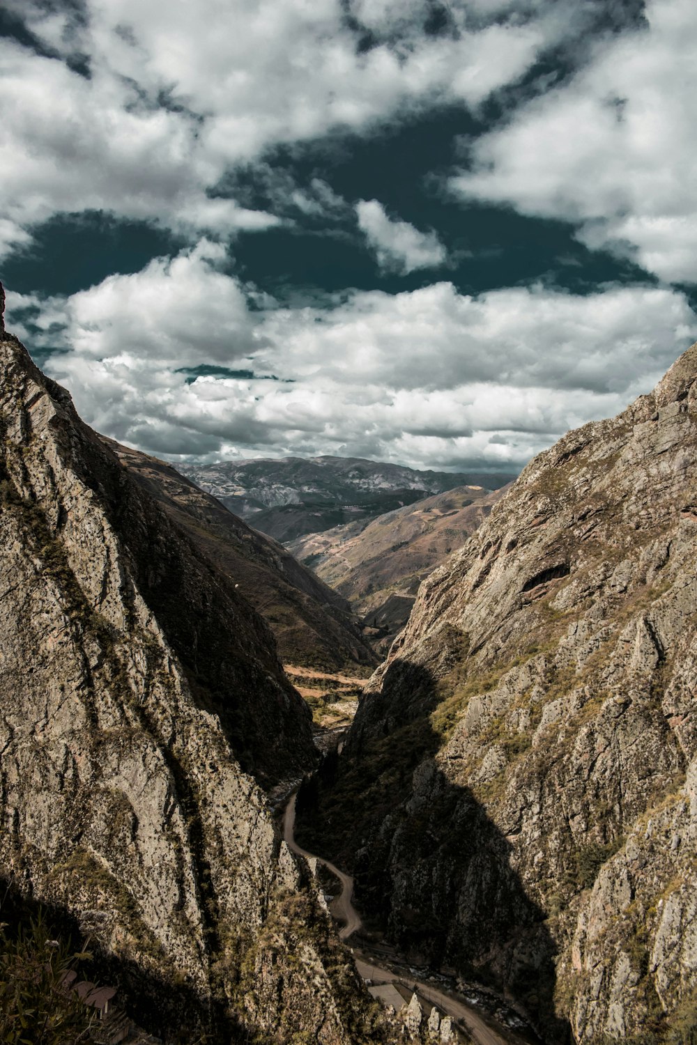 brown rocky mountain under white clouds during daytime