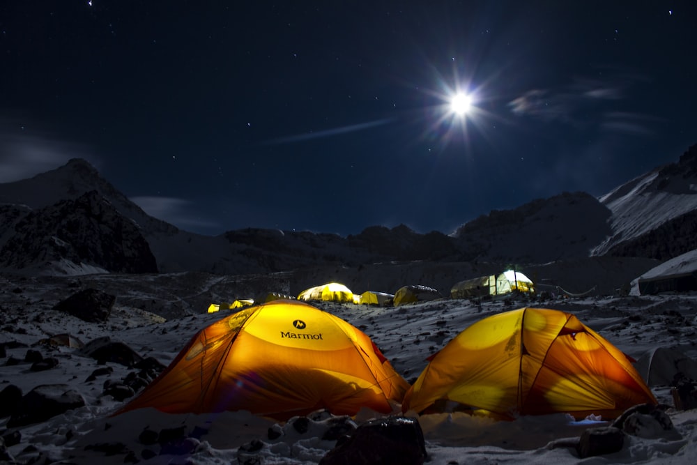 yellow dome tent on snow covered ground during night time