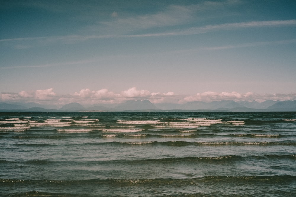 ocean waves under blue sky during daytime