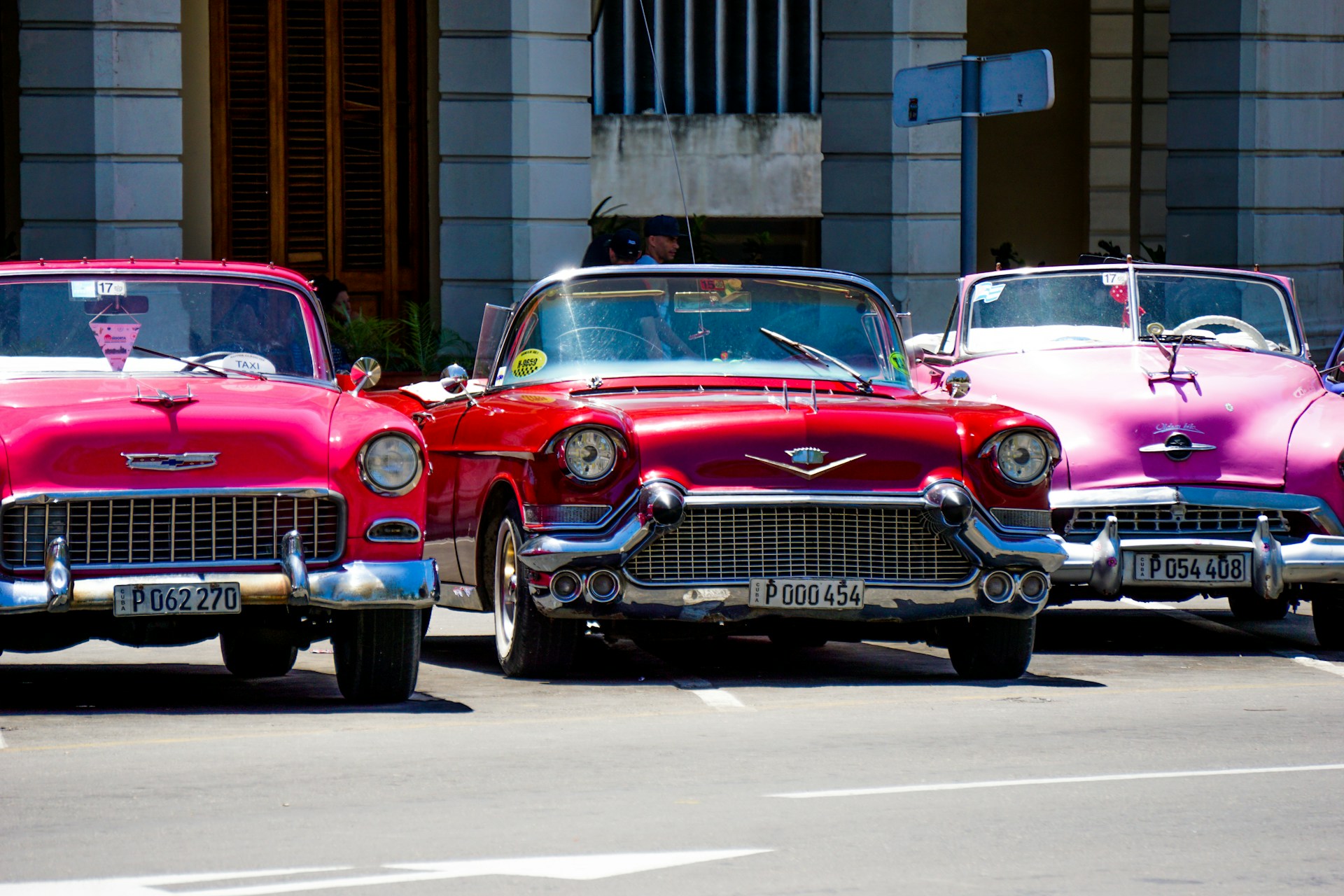 red classic car parked near building during daytime